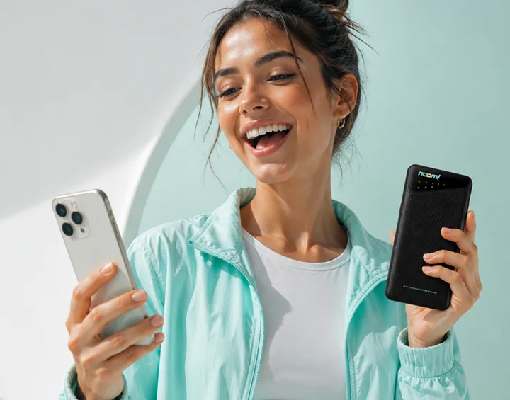 A traveler staying online and charging a phone with one pocket Noomi device